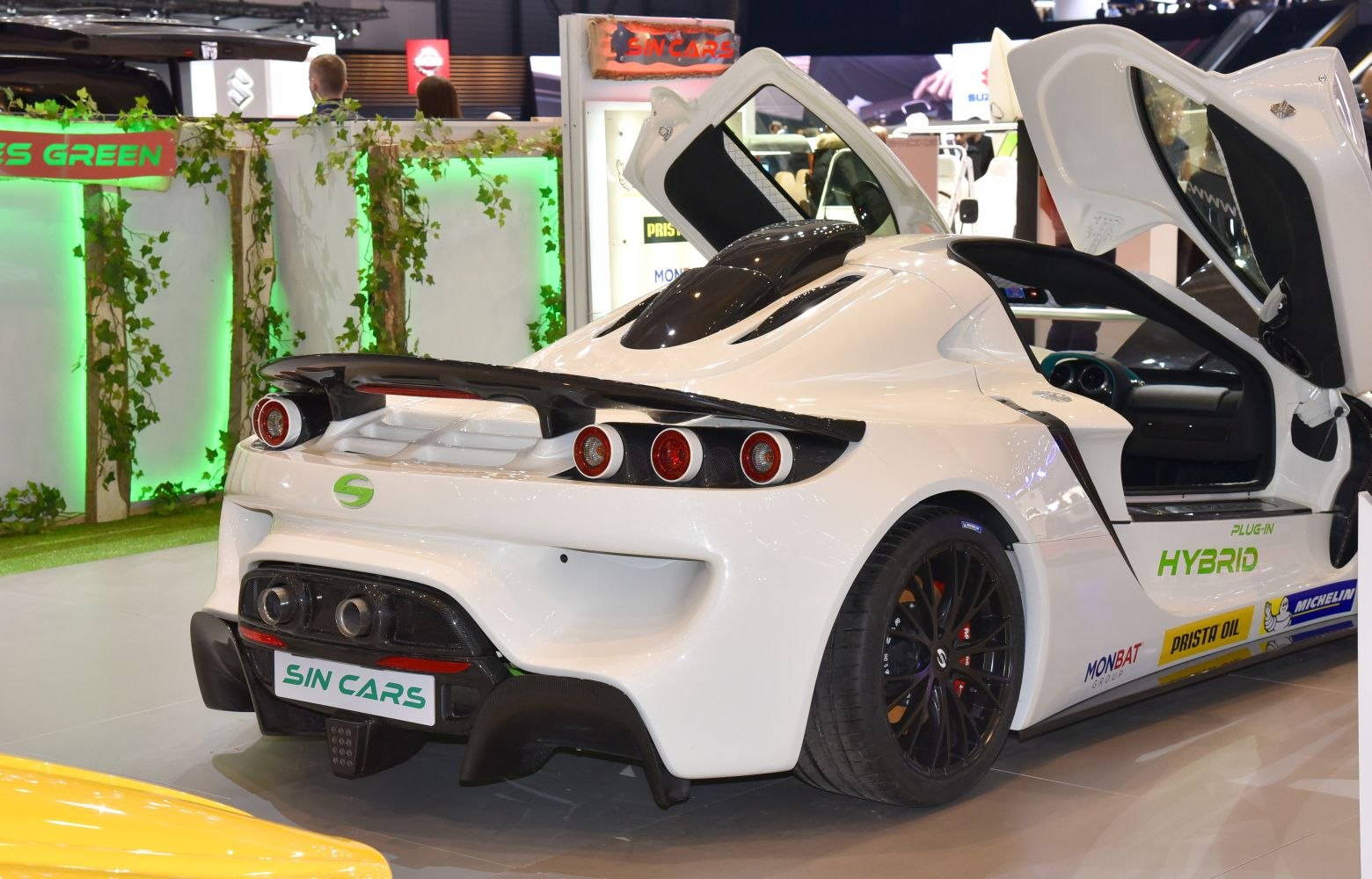 Rear view of hybrid sports car with butterfly doors and quad round taillights