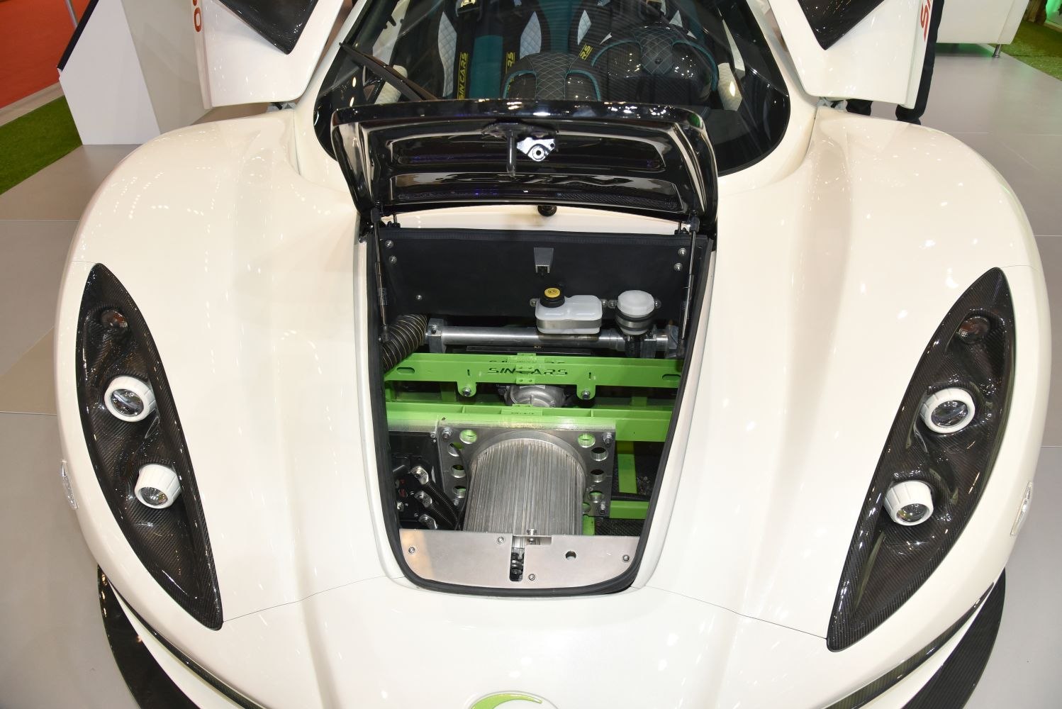Front trunk compartment and paired sleek headlights