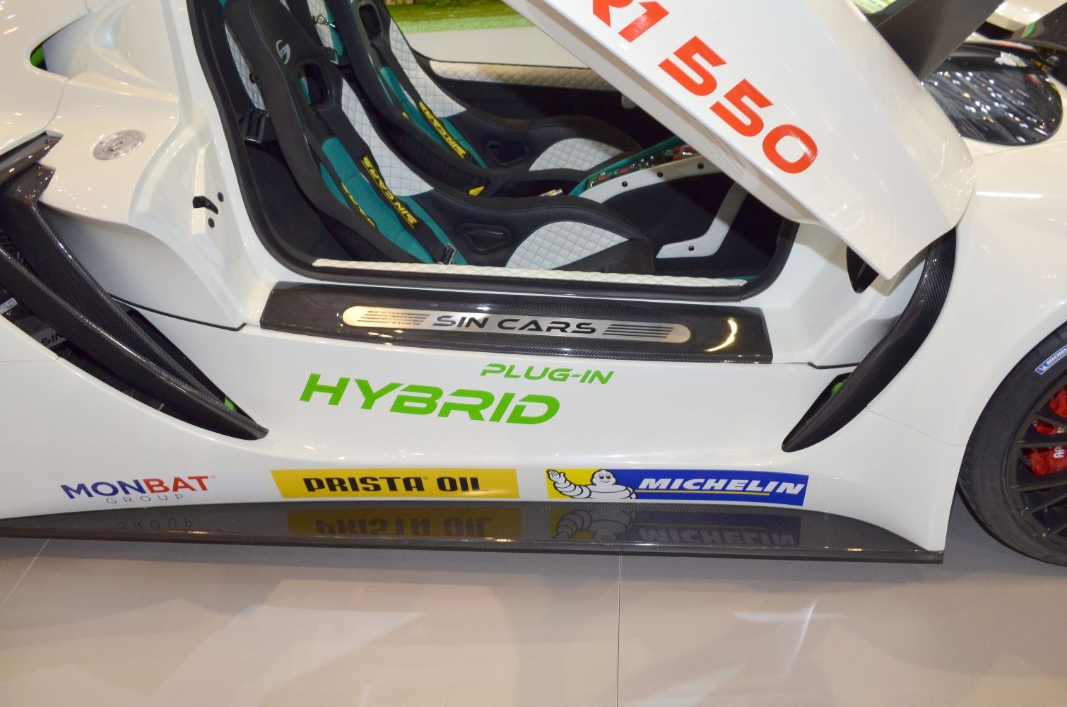 Plug-in hybrid car interior and door sill with sponsor decals
