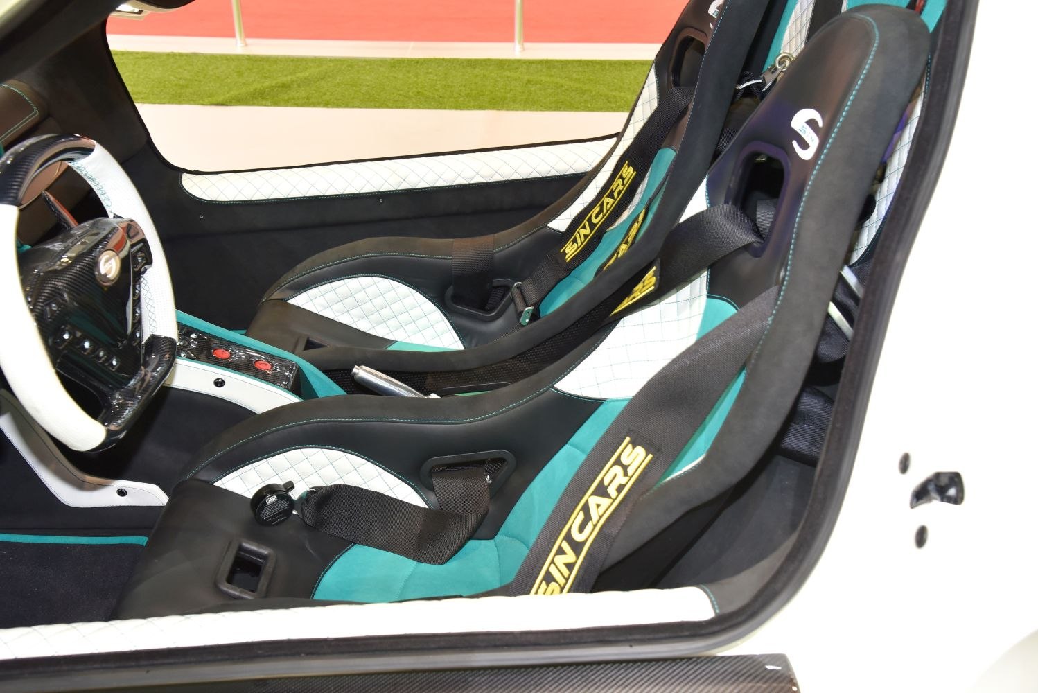 Racing bucket seats with harness belts in a sporty car interior