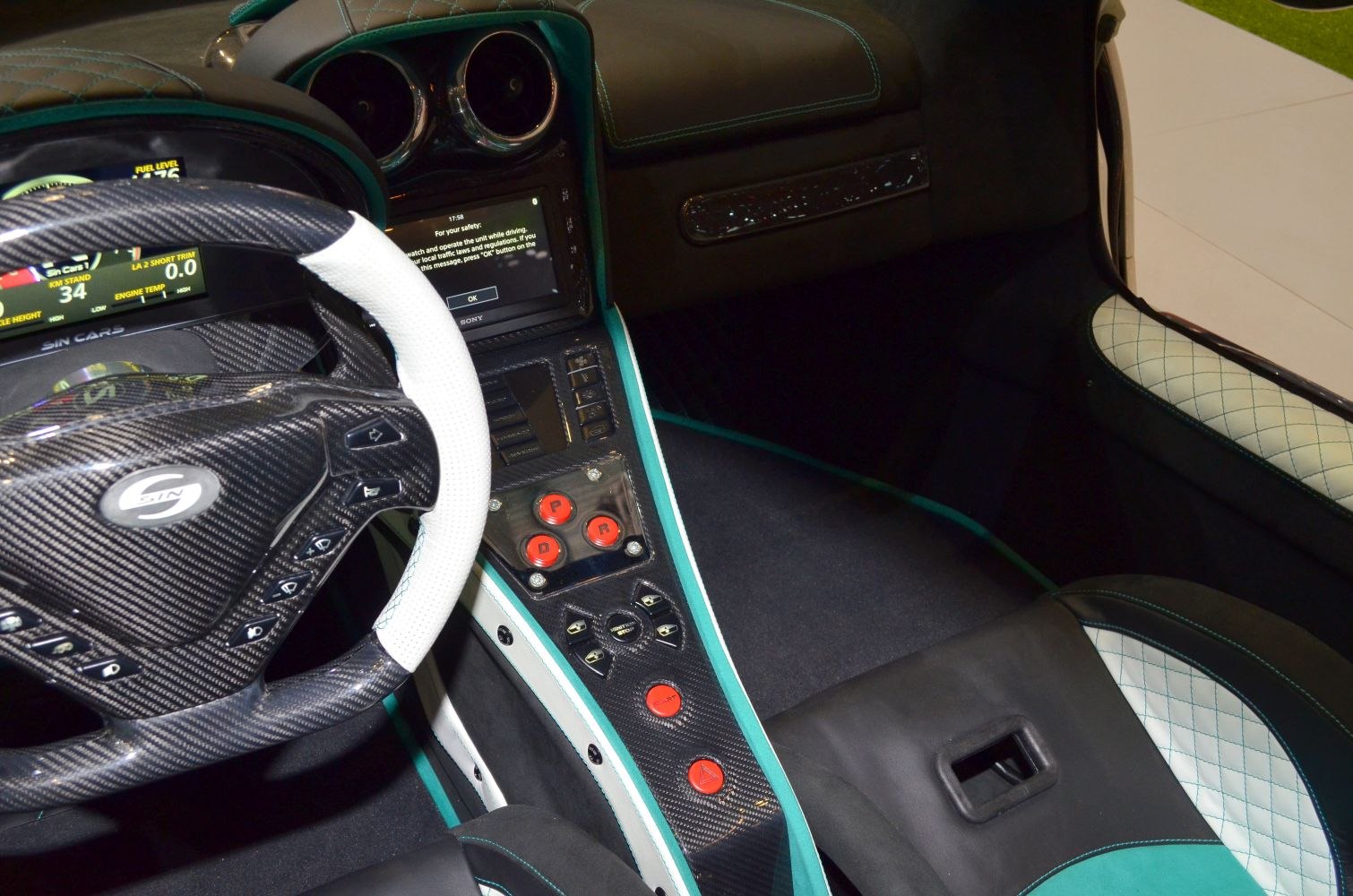 Carbon fiber steering wheel and center console with red control buttons