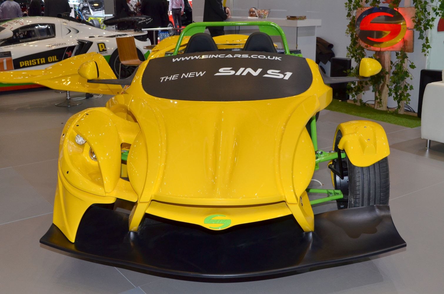 Yellow aerodynamic sports front with exposed front wheels and black splitter