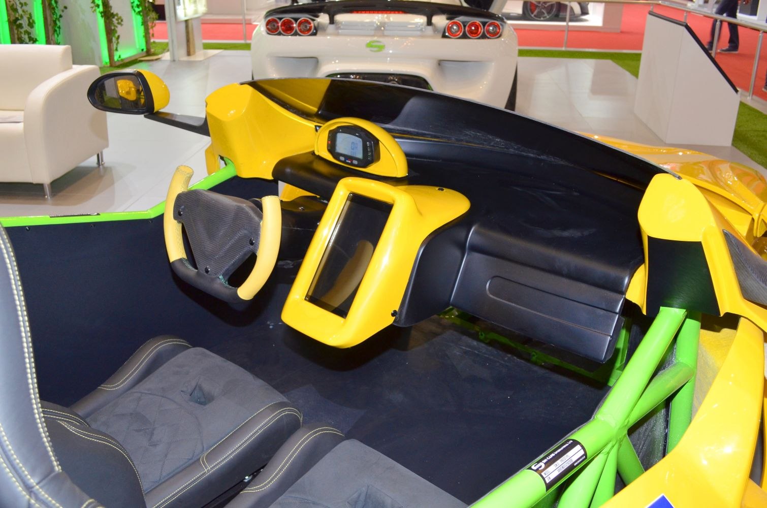 Yellow and black dashboard with digital gauge and racing-style steering wheel