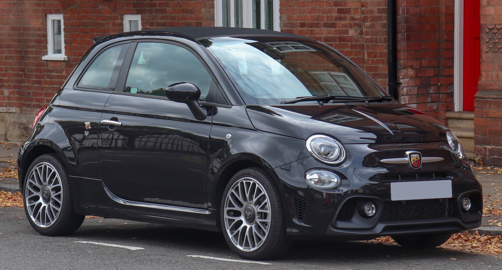 Sporty compact hatchback with round headlights and multi-spoke alloy wheels