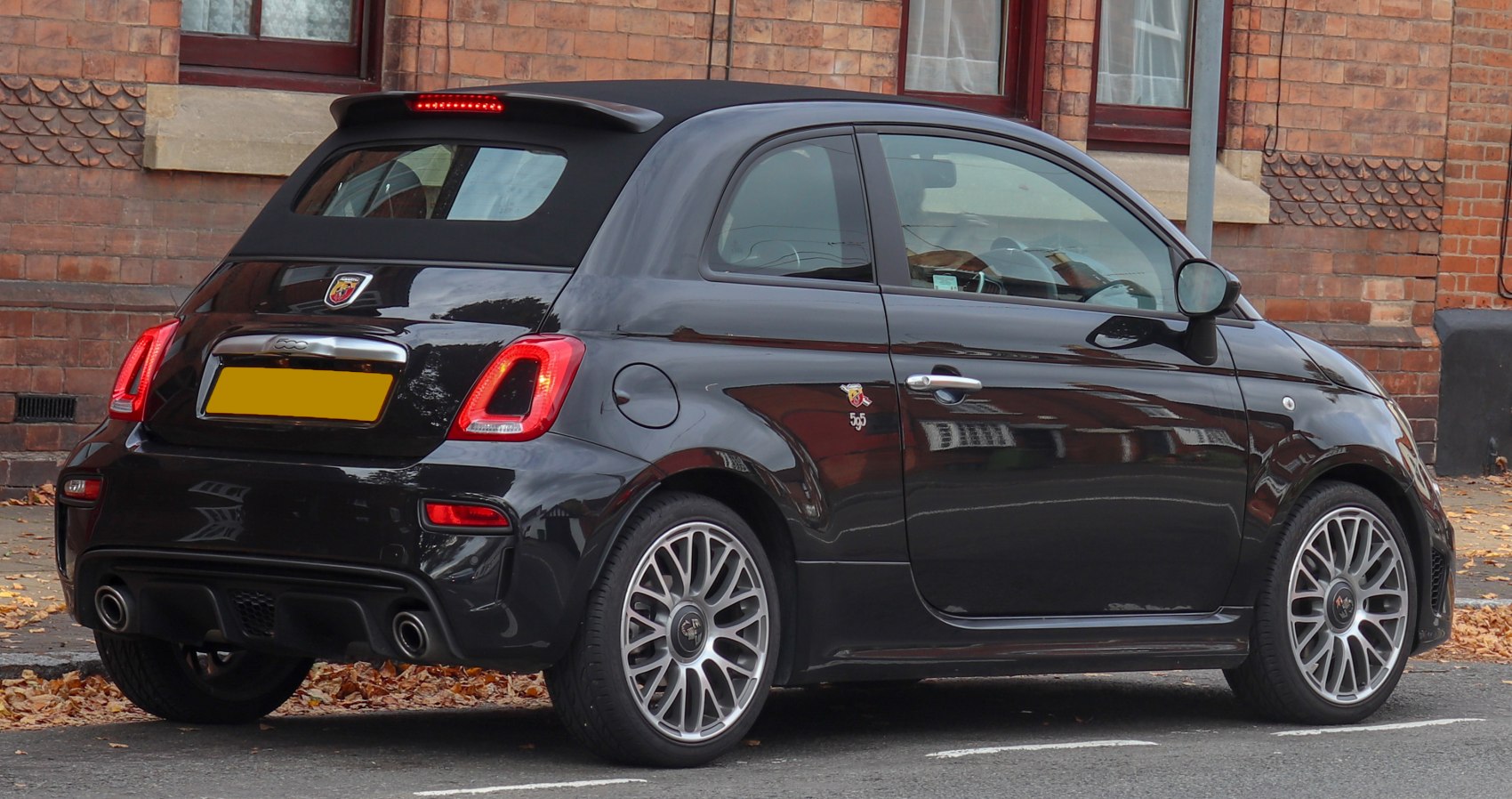 Rear side view of convertible with dual exhaust and alloy wheels