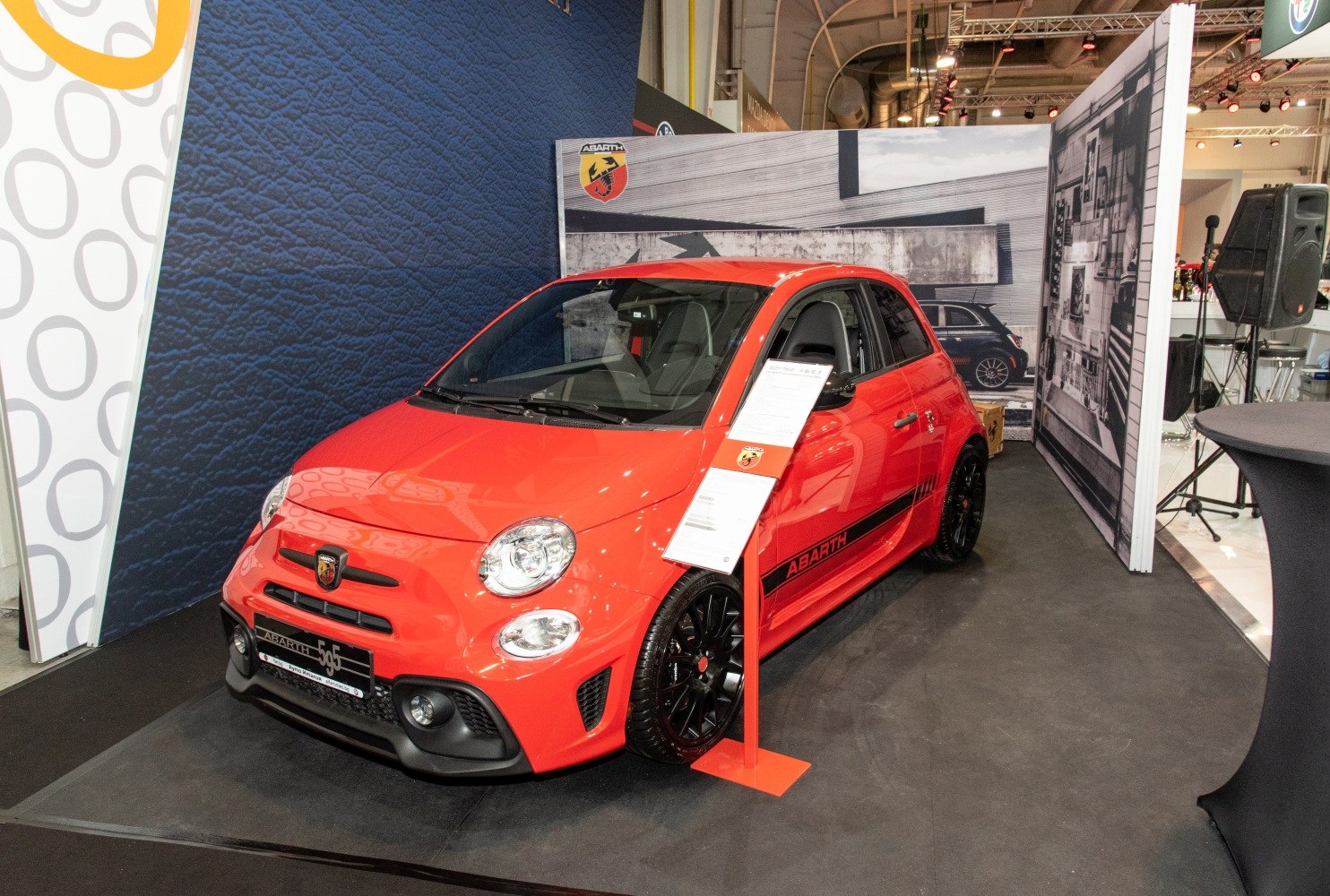 Red 5-door hatchback with black alloy wheels and sporty front bumper