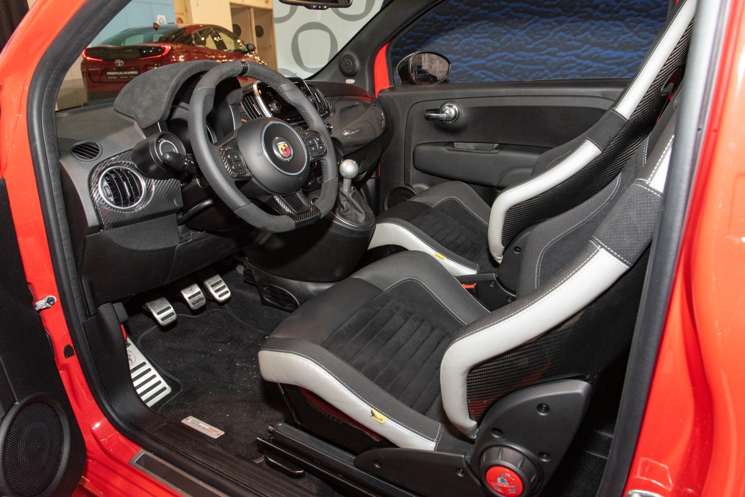 Sporty racing bucket seats and carbon-fiber dashboard in compact performance car interior