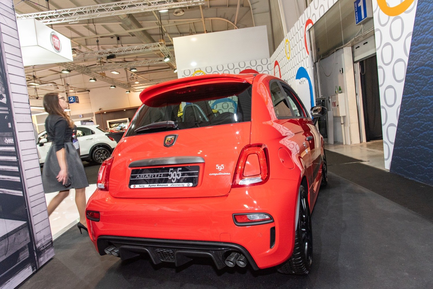 Sporty rear view of red hatchback with dual exhausts and diffuser