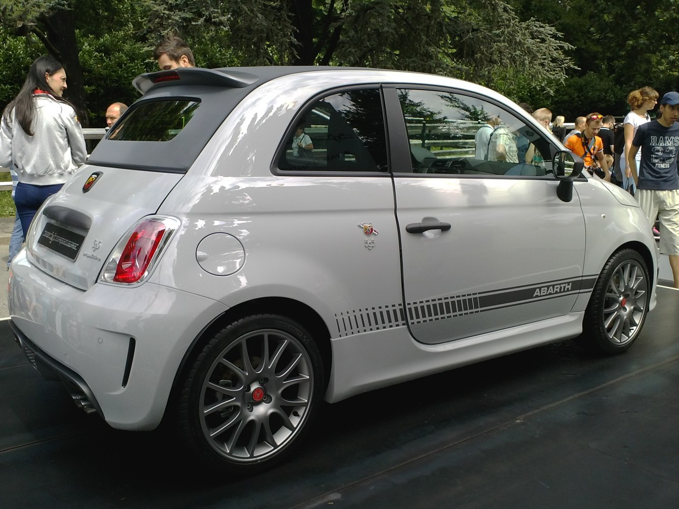 Compact convertible with rear spoiler, racing stripes, and sporty wheels