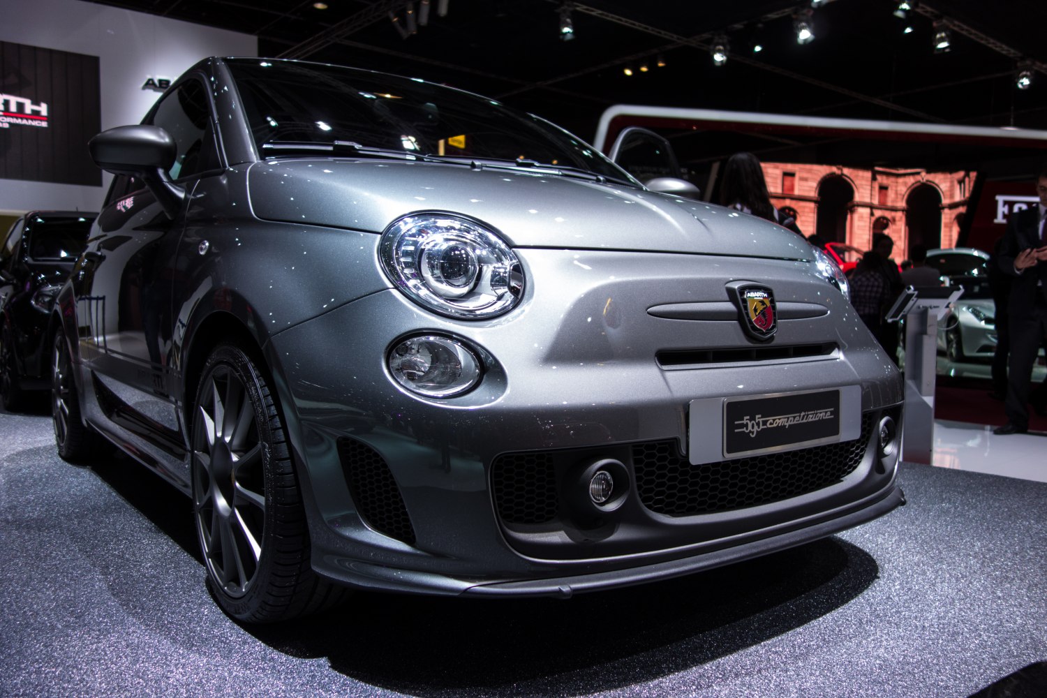 Close-up of circular headlights and aggressive front grille with fog lights.