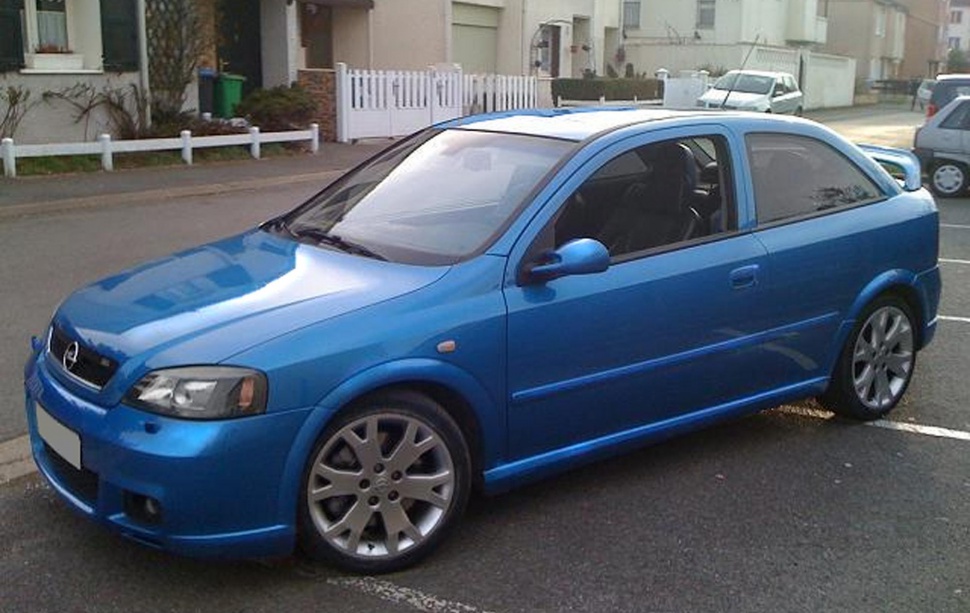 Blue hatchback with sporty alloy wheels and rear spoiler