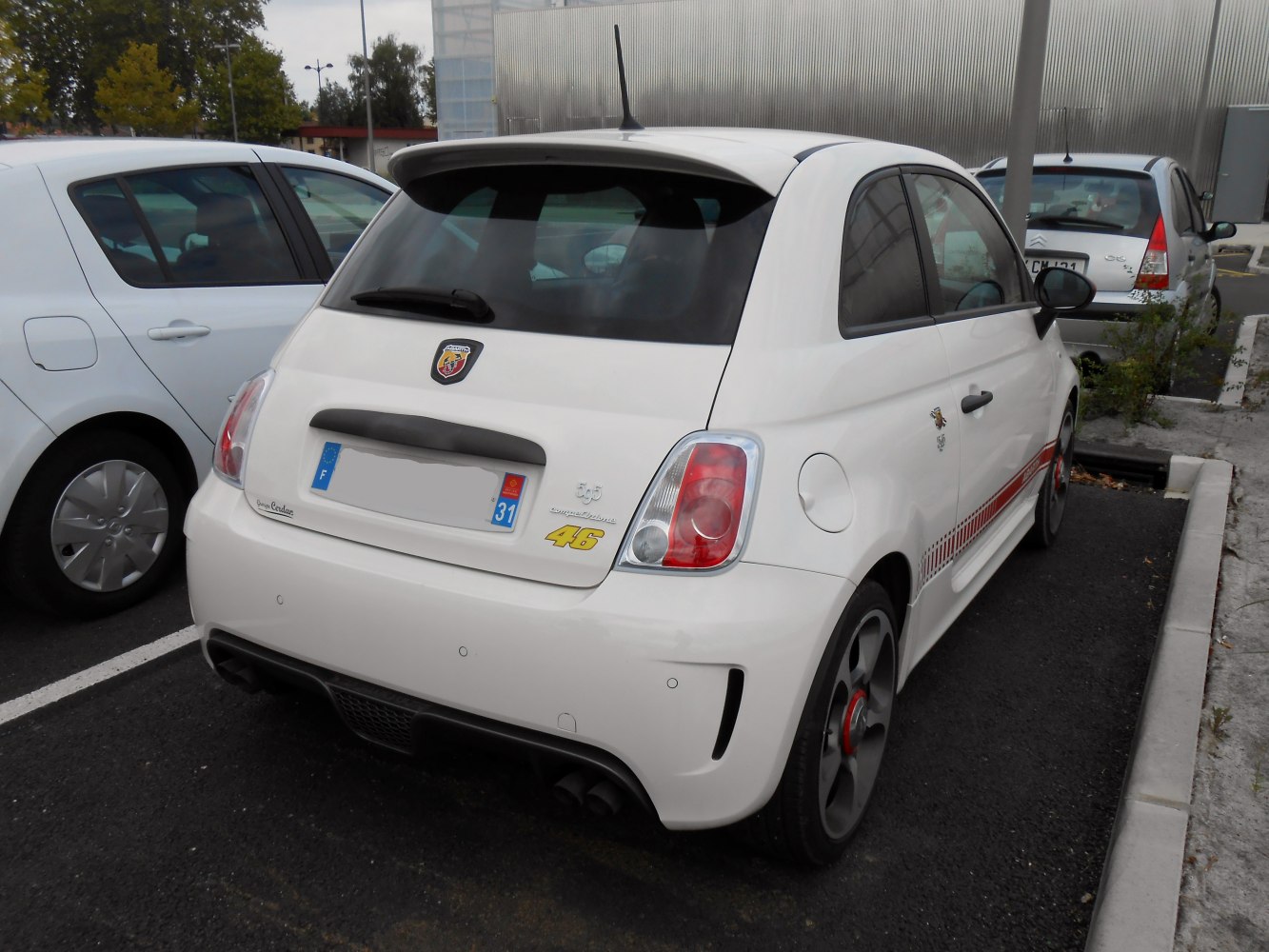 Rear view of compact hatchback with sports spoiler and dual exhaust