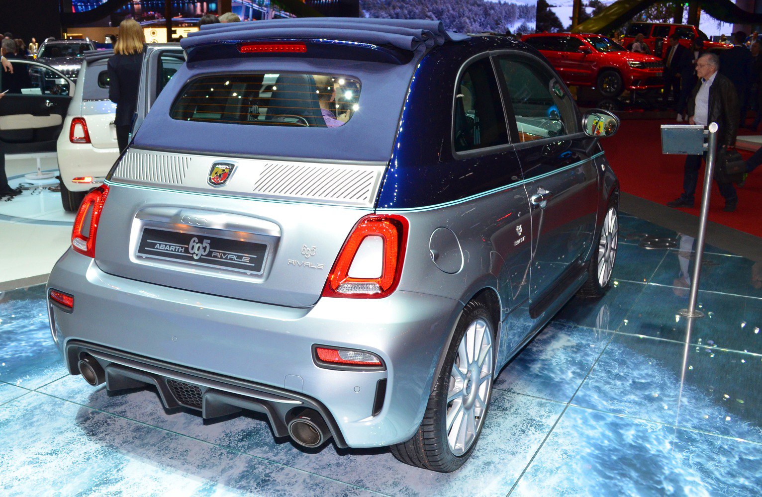 Rear view of silver compact car with soft top convertible roof