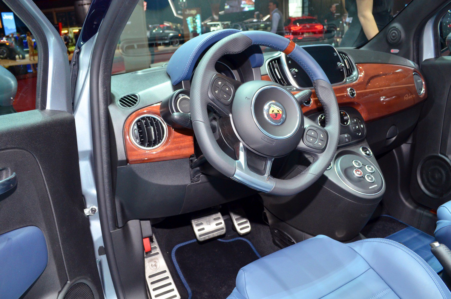 Blue leather steering wheel and wood dashboard interior details
