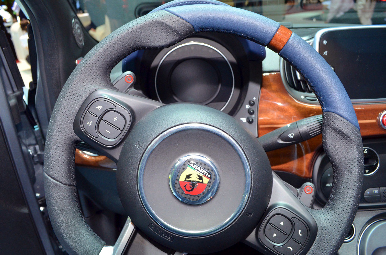 Steering wheel with leather, wood trim, and control buttons
