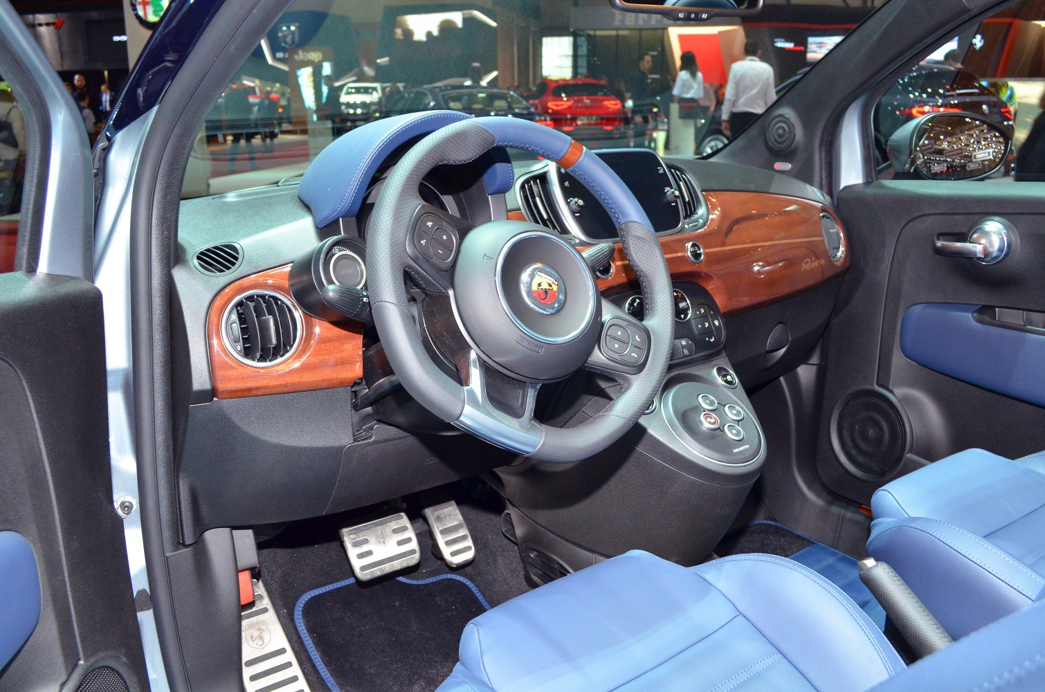 Blue leather seats and polished wood dashboard with sporty steering wheel