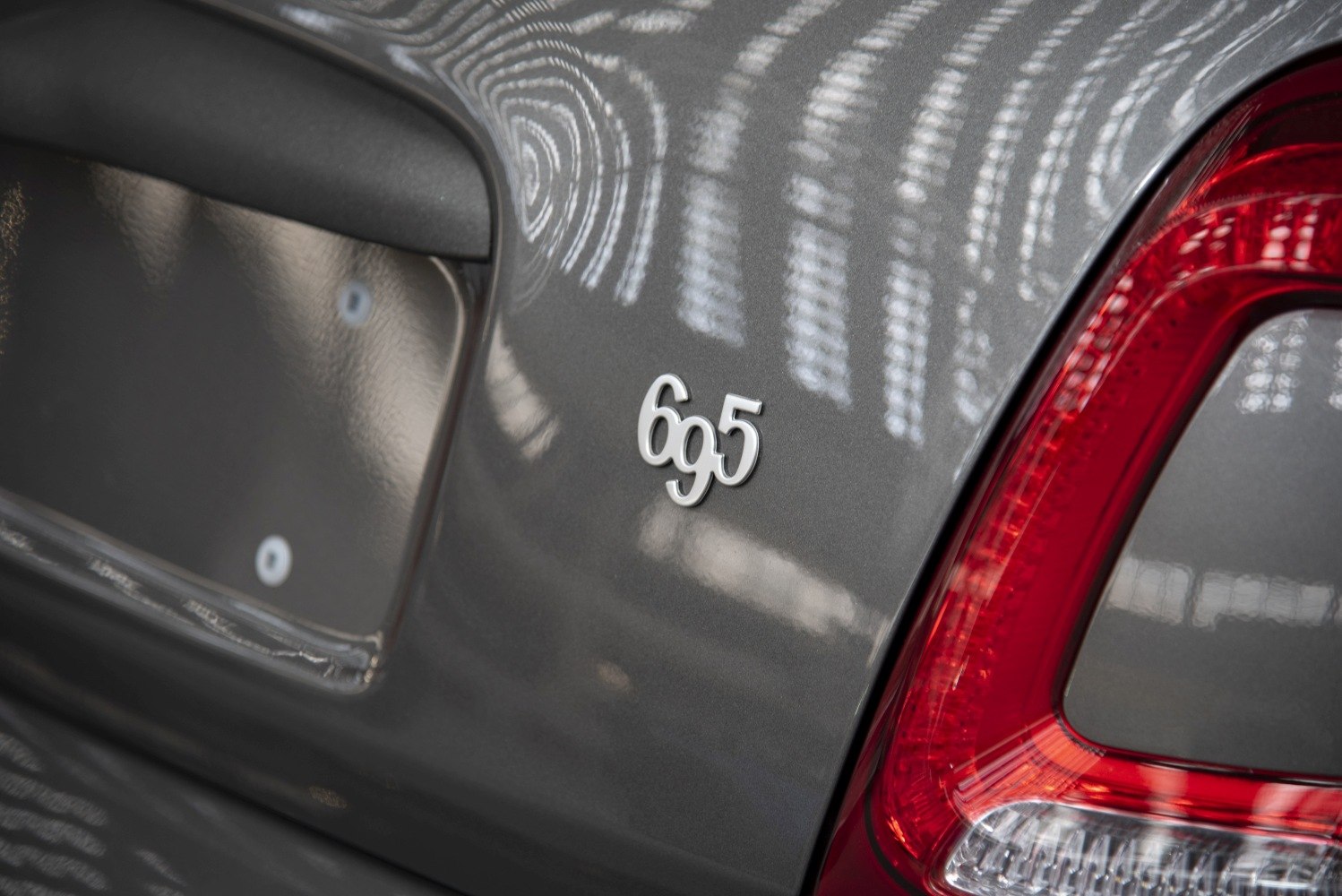 Close-up of rear badge and tail light on gray vehicle