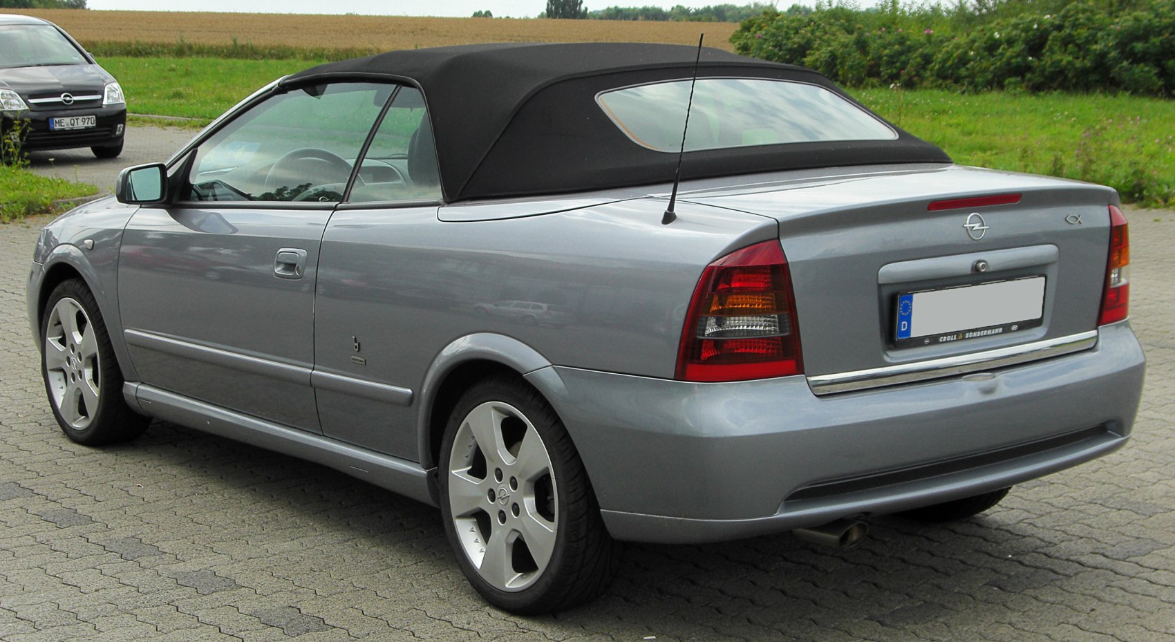 Soft top convertible rear side view with alloy wheels