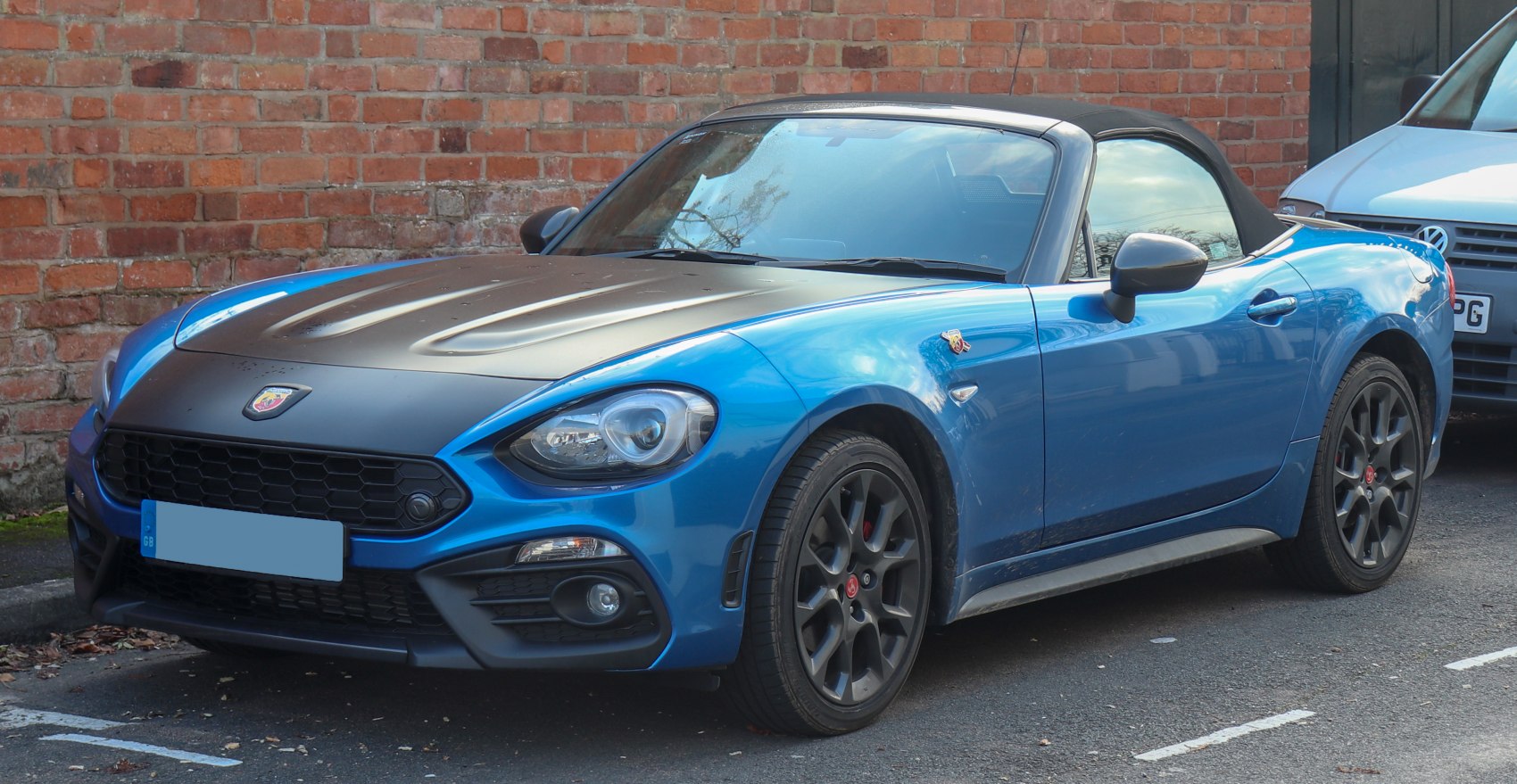 Blue roadster with matte black hood and black alloy wheels