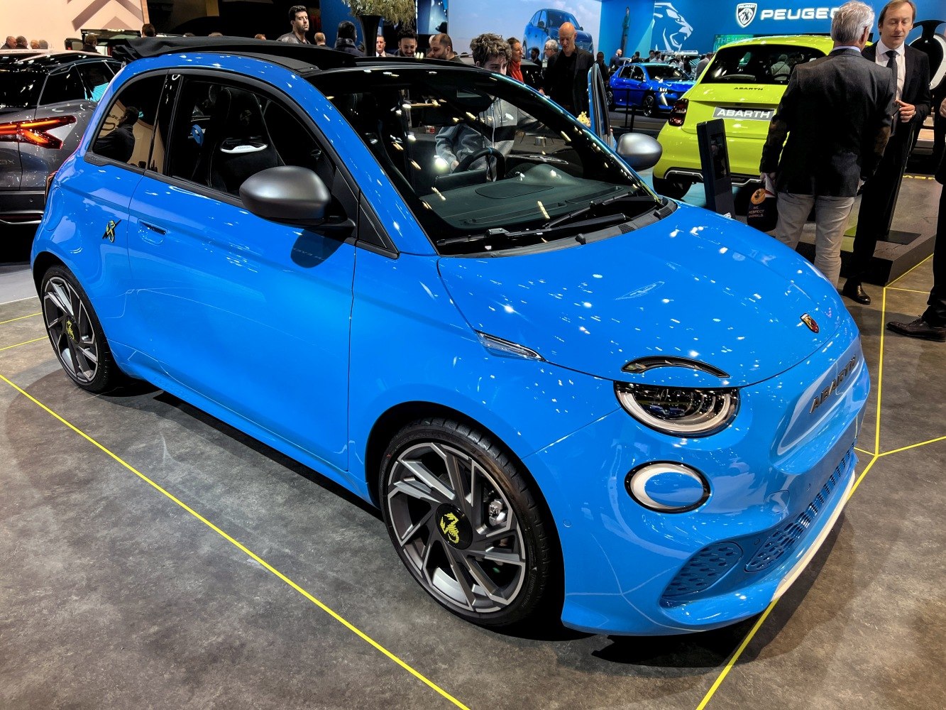 Blue electric compact car with sporty alloy wheels and sleek design