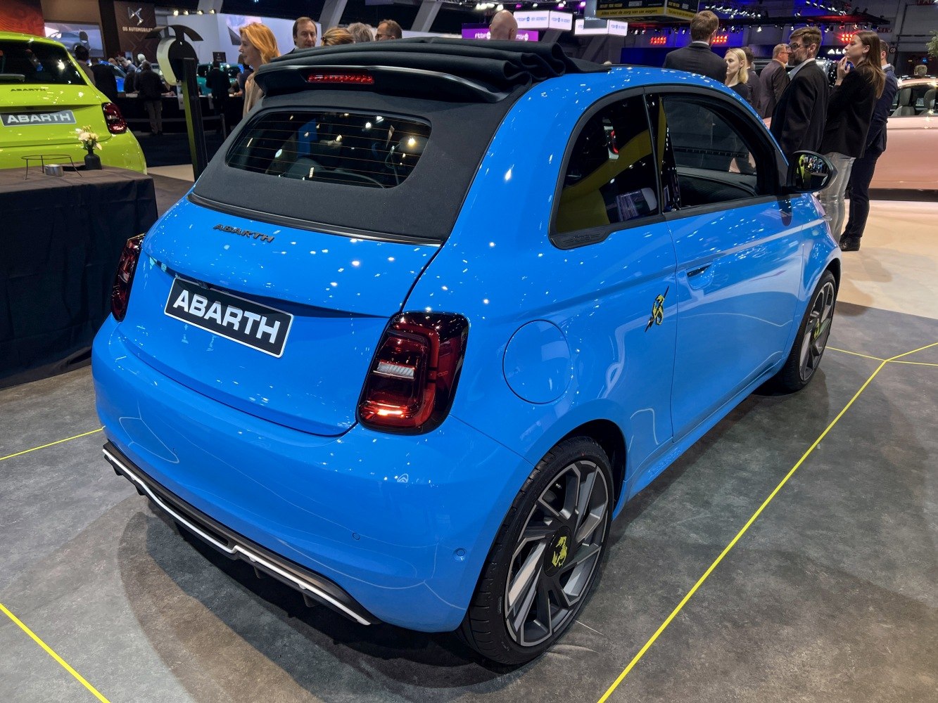 Electric convertible hatchback with soft-top roof and sporty alloy wheels in blue.