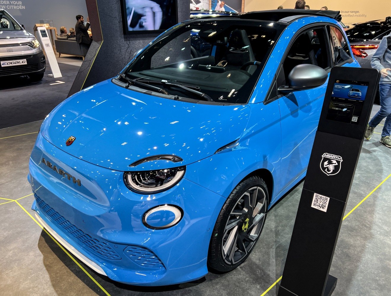 Blue electric convertible with modern LED headlights and sporty rims