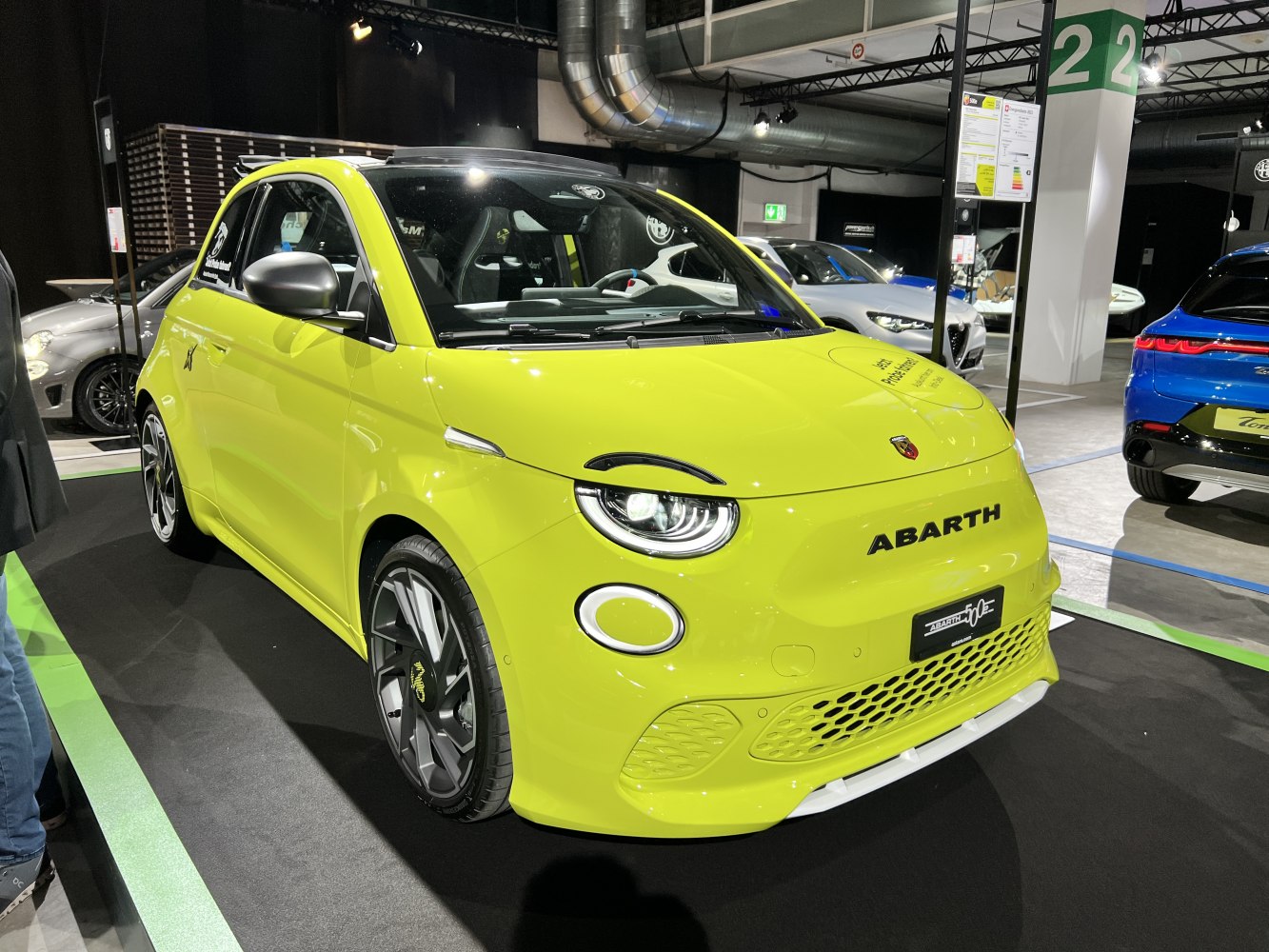 Bright yellow electric hatchback with LED headlights and sporty wheels.