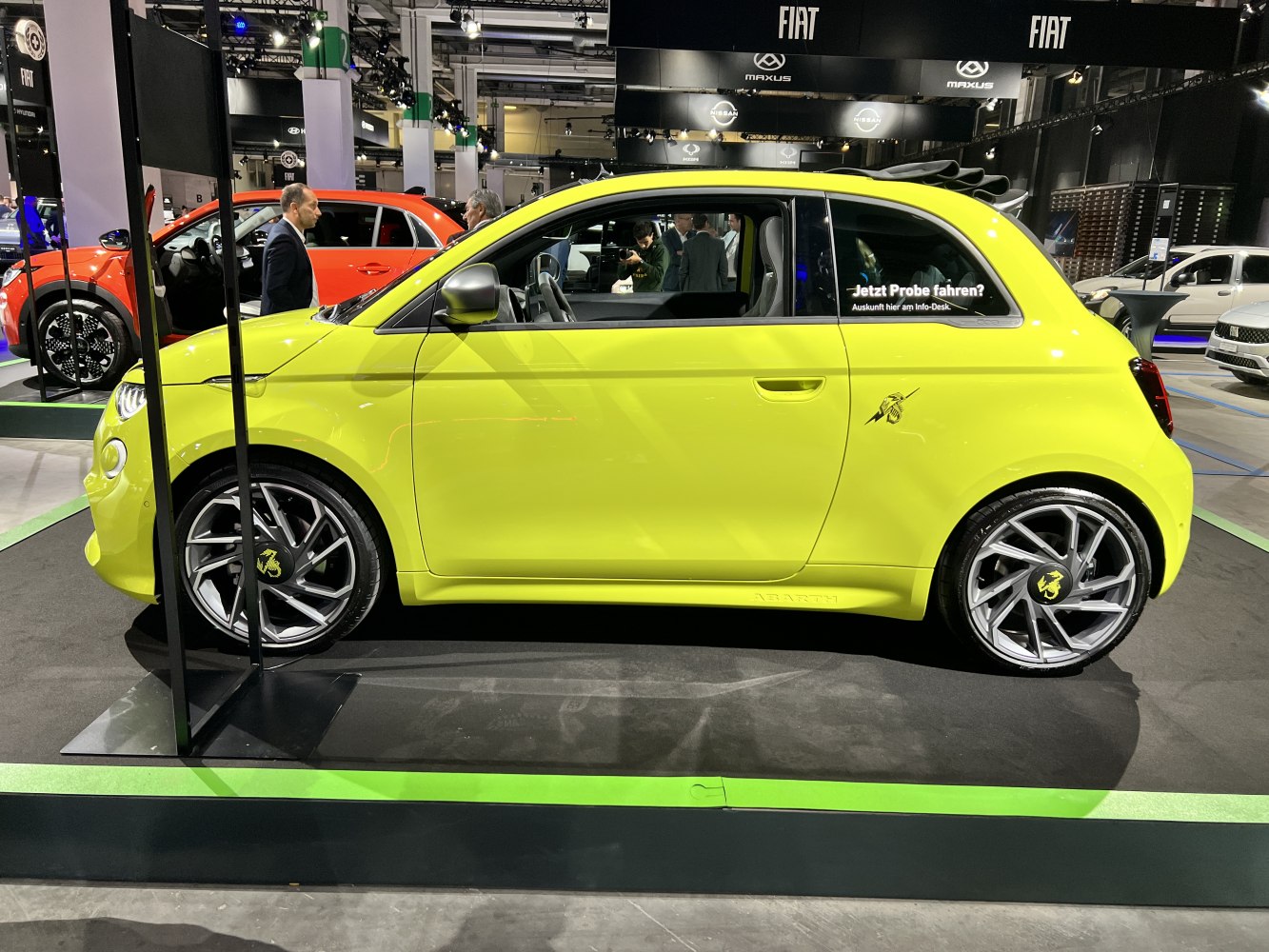 Bright yellow electric compact convertible with sporty alloy wheels and open roof