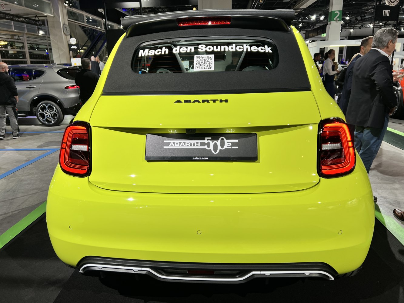 Rear view of bright yellow compact convertible with modern tail lights.