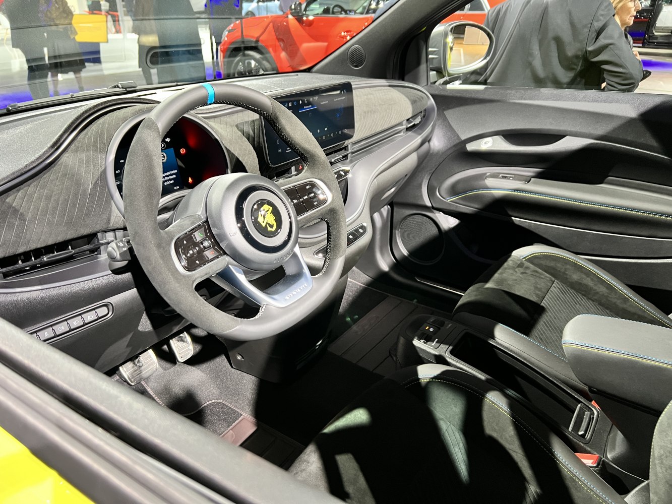 Sporty steering wheel and digital infotainment display in car interior