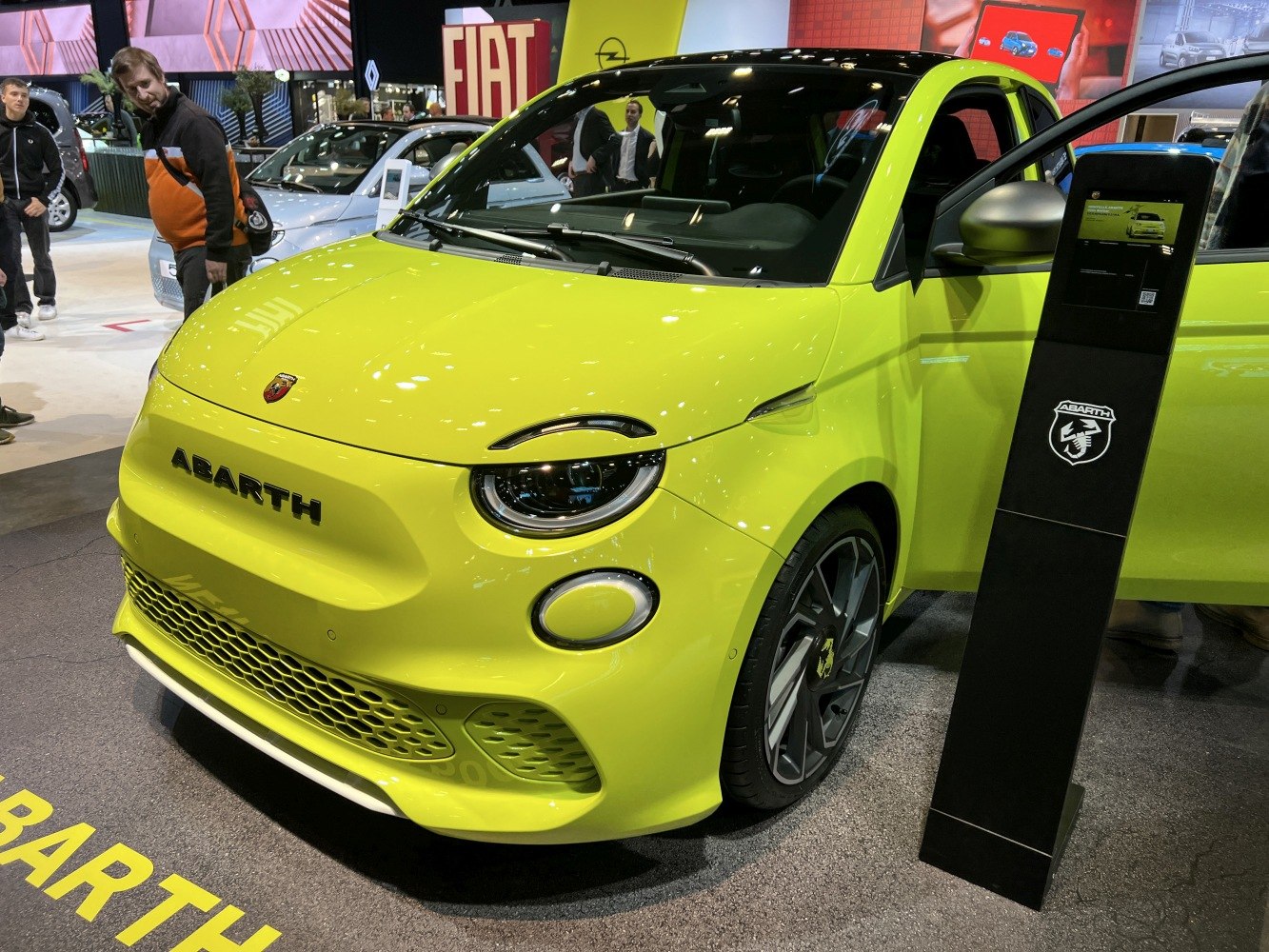 Close-up front view of an electric compact car with round headlights and sporty grille