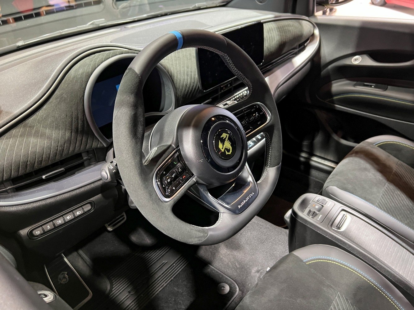 Sporty steering wheel and sleek digital dashboard with detailed upholstery