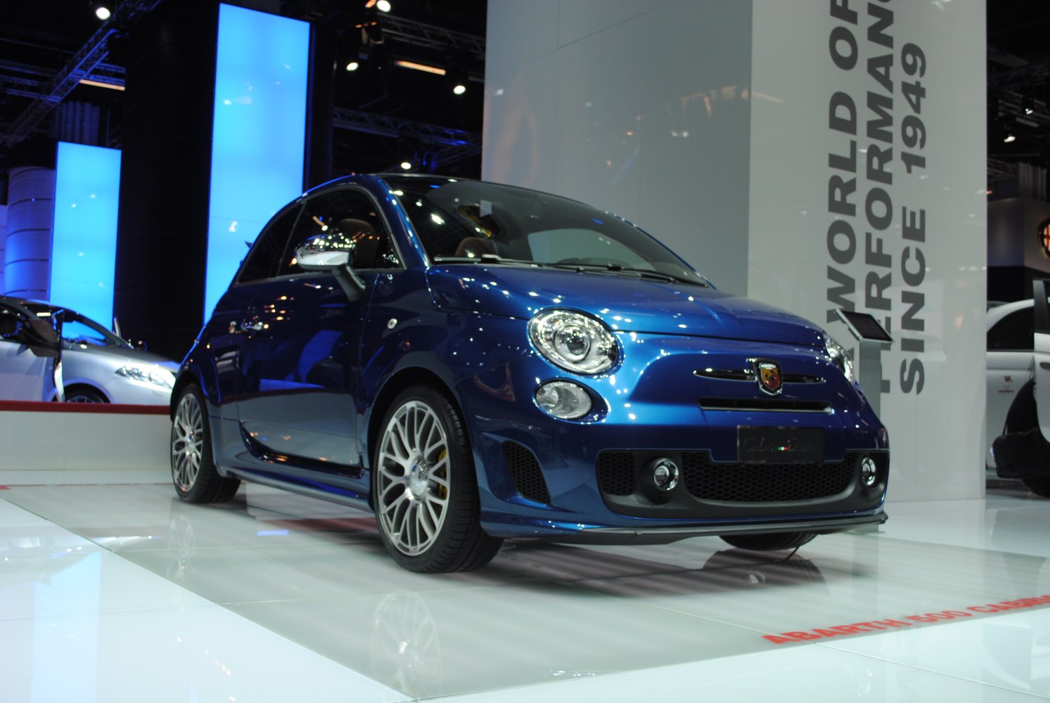 Distinctive round headlights, mesh grille, alloy wheels on a compact sporty hatchback