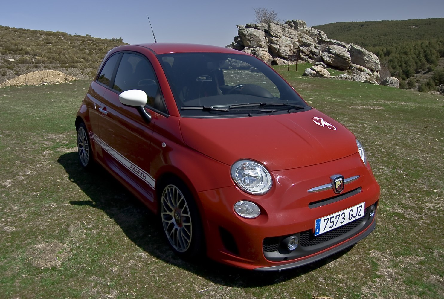 Red sporty hatchback with alloy wheels and front angle view