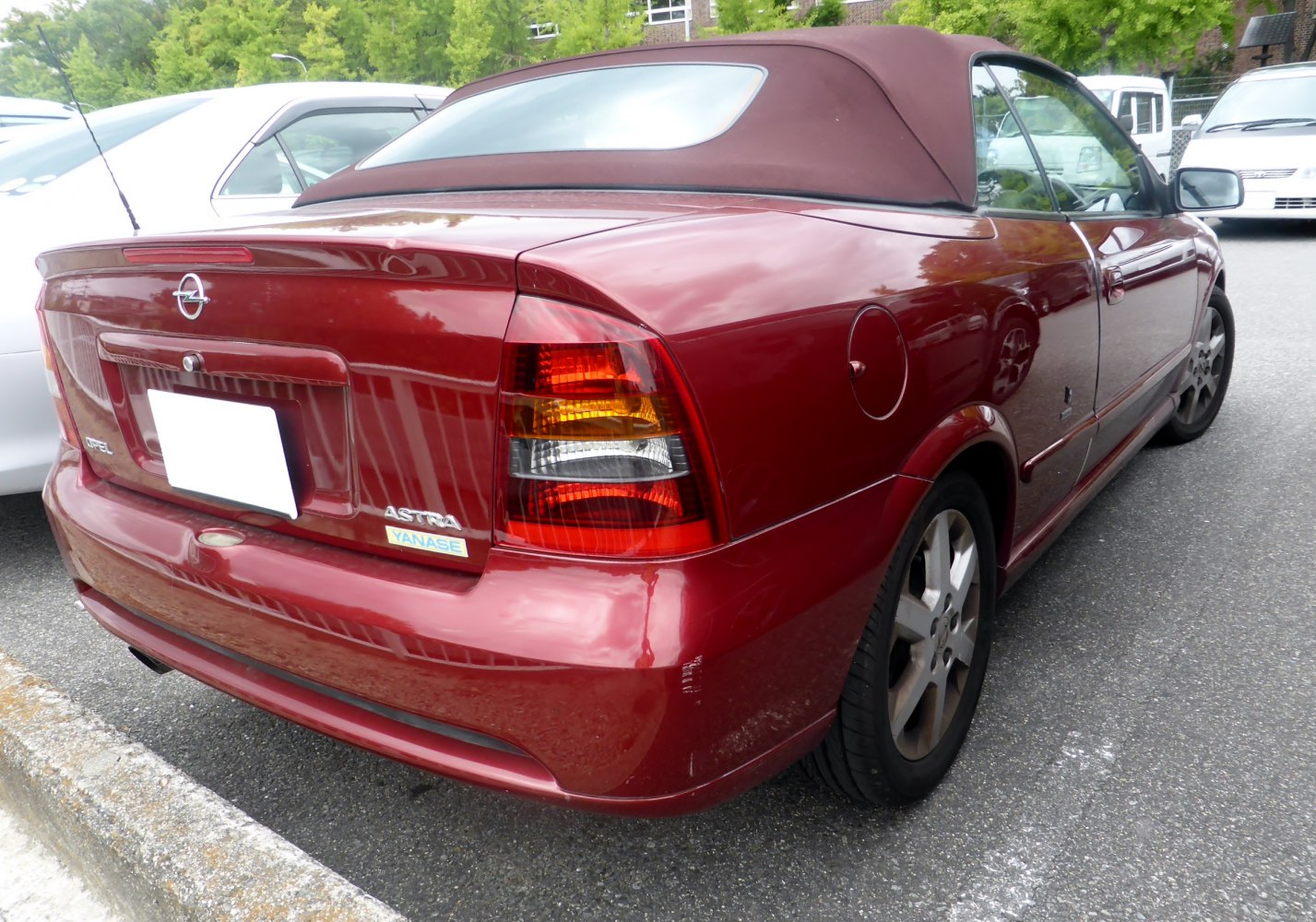 Rear view of a soft top convertible with alloy wheels and multi-colored taillights