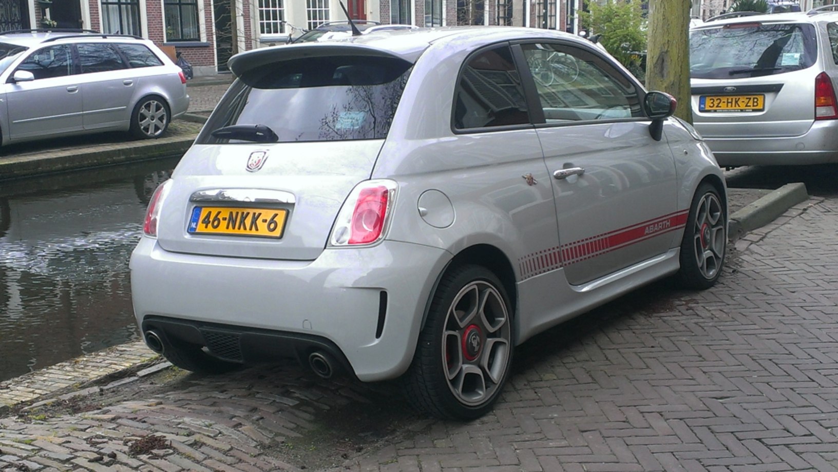 Rear view with sporty wheels, dual exhaust, side decal