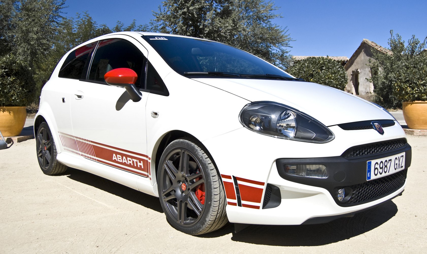 Sporty white hatchback with red accents and black alloy wheels