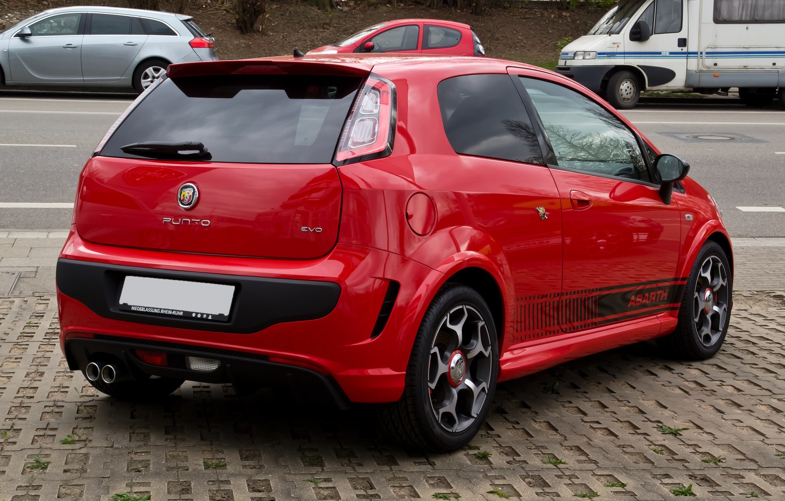 Red hatchback rear with dual exhaust and sporty rear bumper