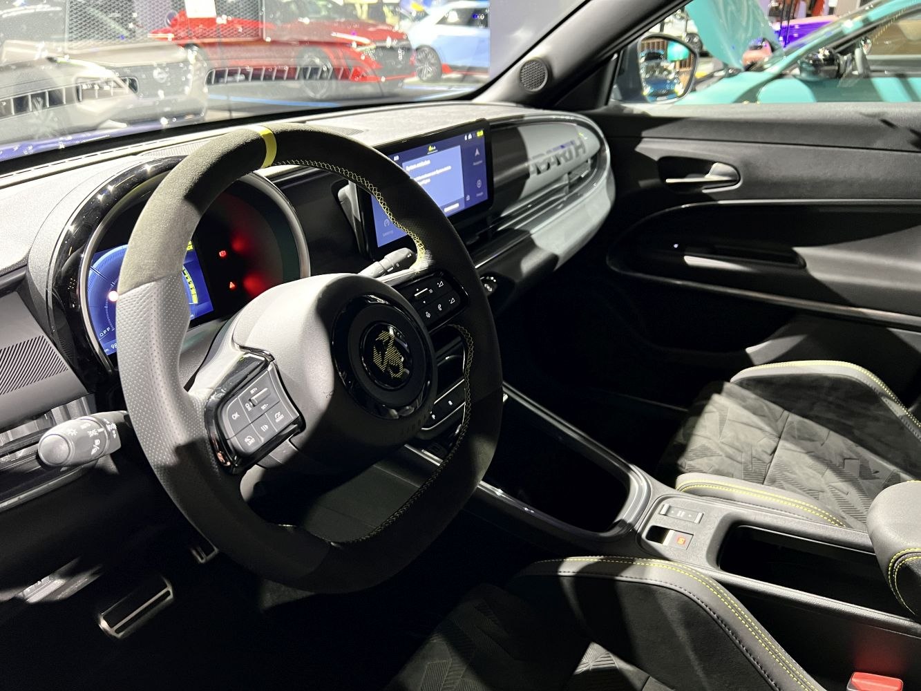 Sporty steering wheel and digital instrument cluster with infotainment screen