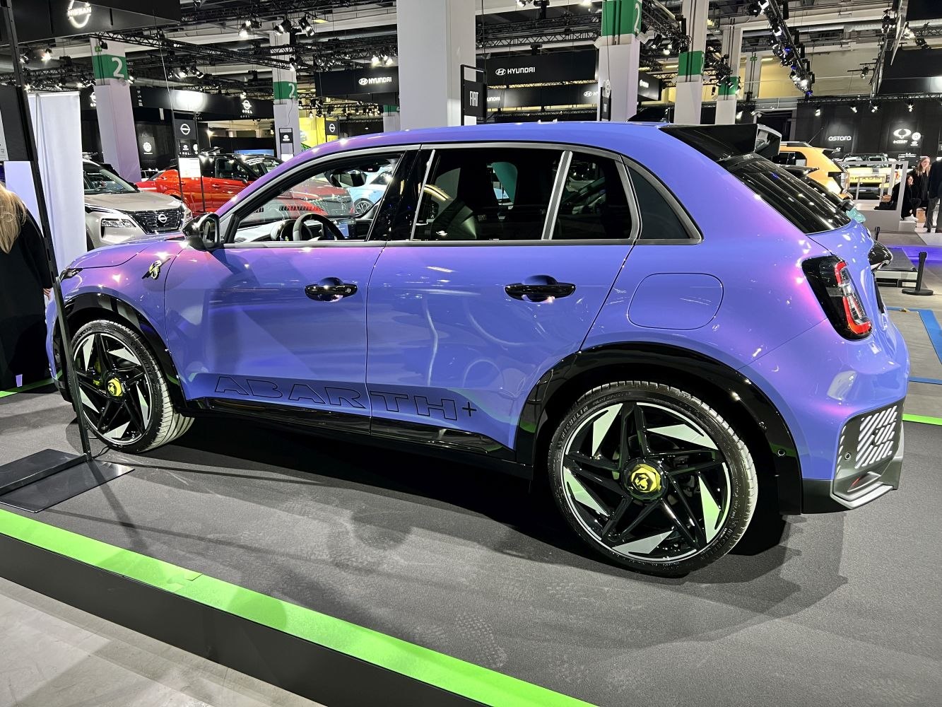 Side profile of a purple electric SUV with sporty wheels and sleek styling