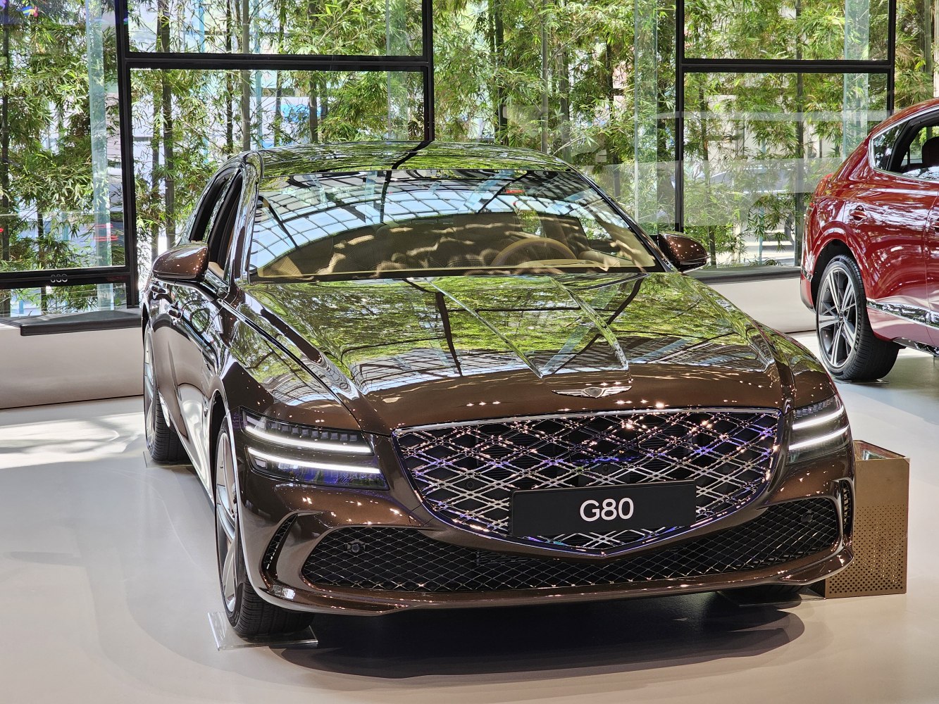 Front view of a luxury sedan with LED headlights and intricate grille design