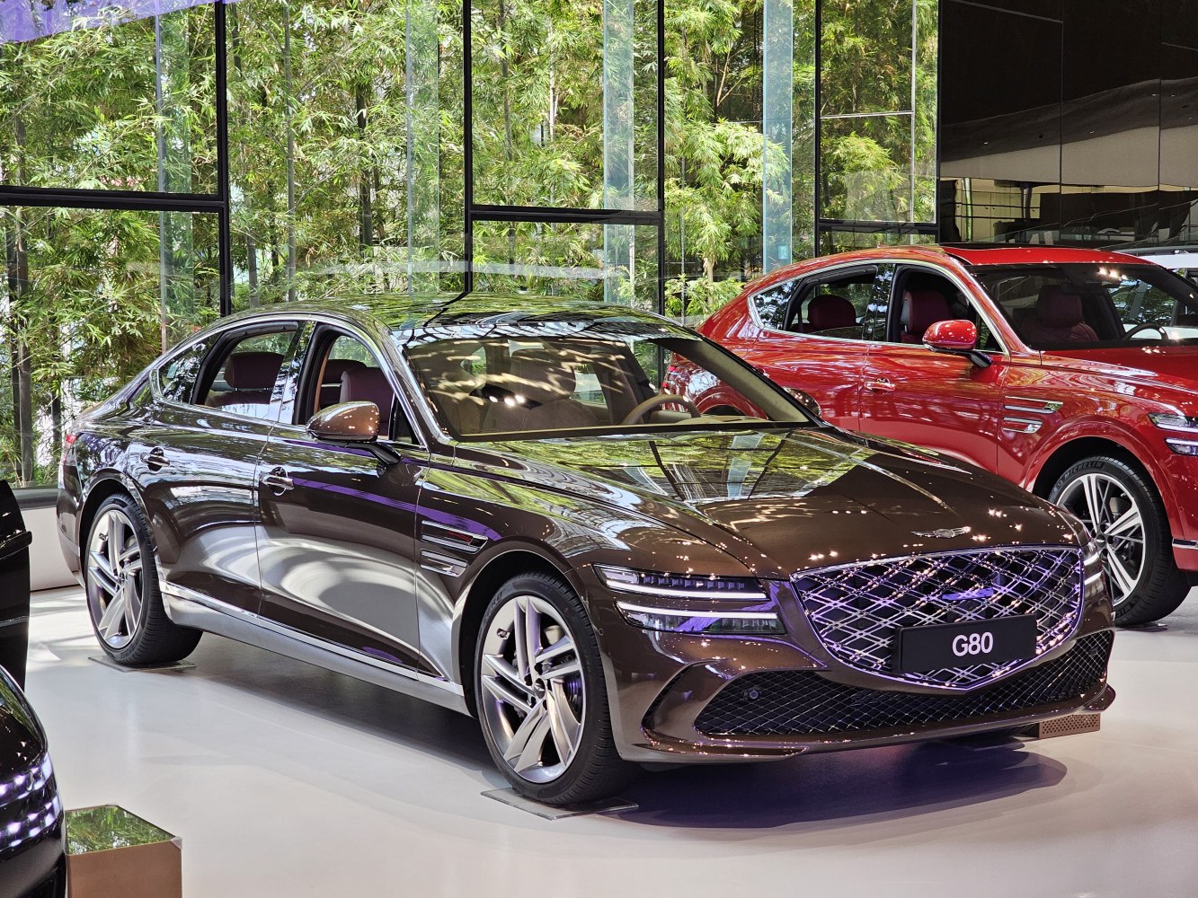 Luxury sedan front side with diamond-pattern grille and split LED headlights