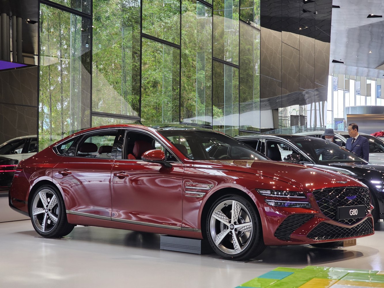 Red luxury sedan with split LED headlights and five-spoke alloy wheels