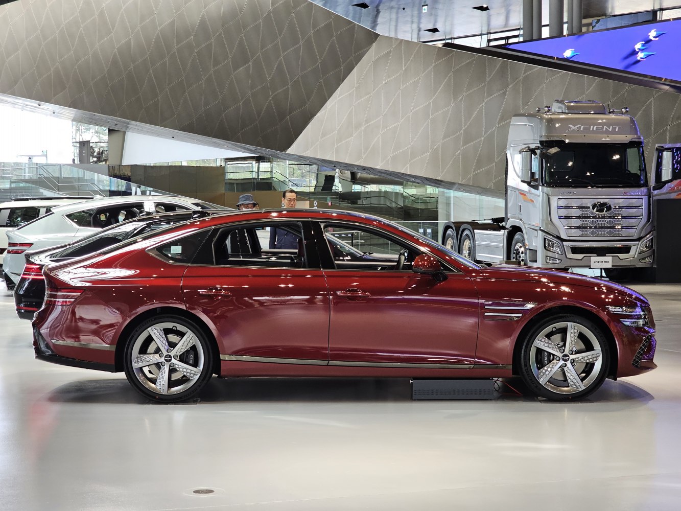 Sleek sedan side profile with distinctive alloy wheels