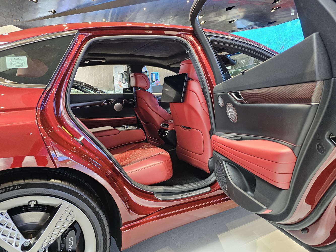 Rear interior with red leather seats and entertainment screens