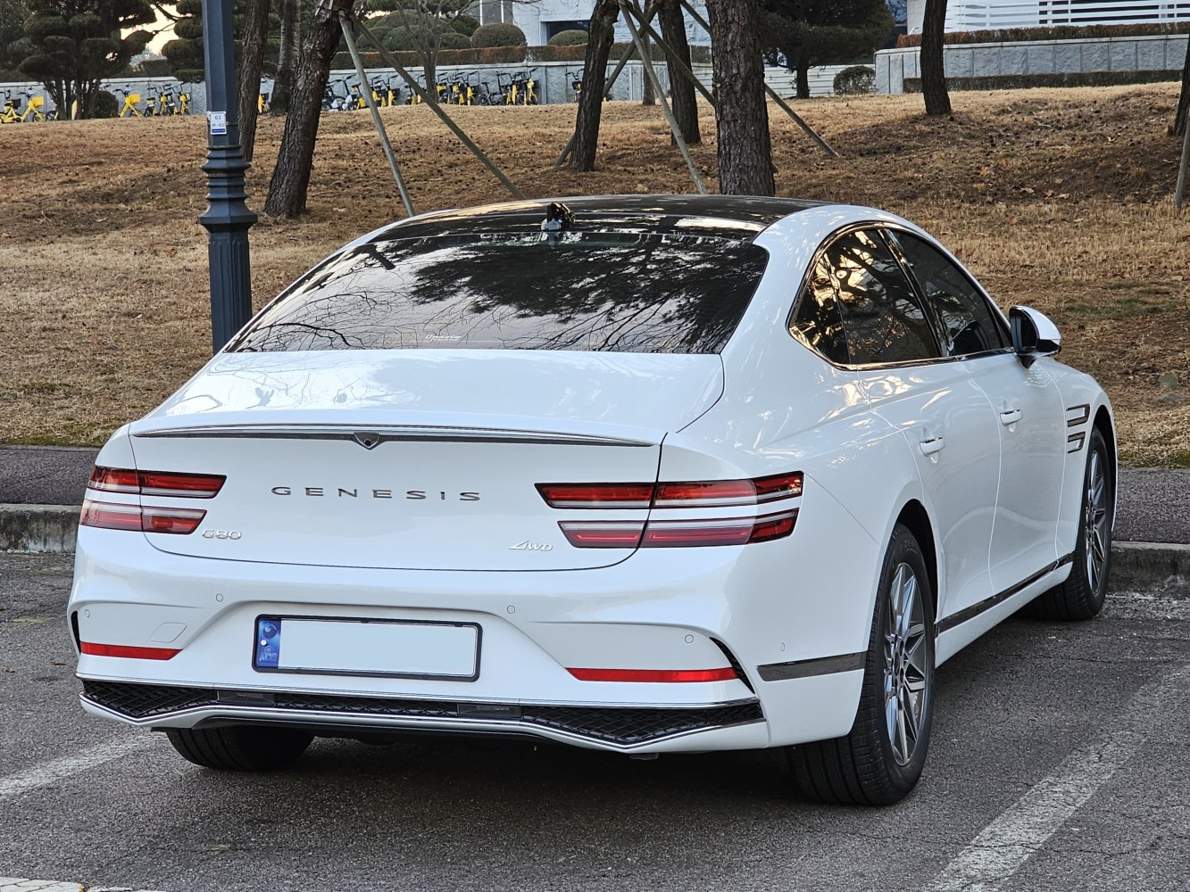 Rear view of a white sedan with distinctive LED tail lights and sleek aerodynamic styling.