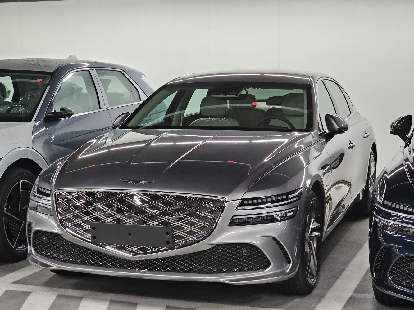 Luxury sedan with diamond-pattern grille and sleek split LED headlights