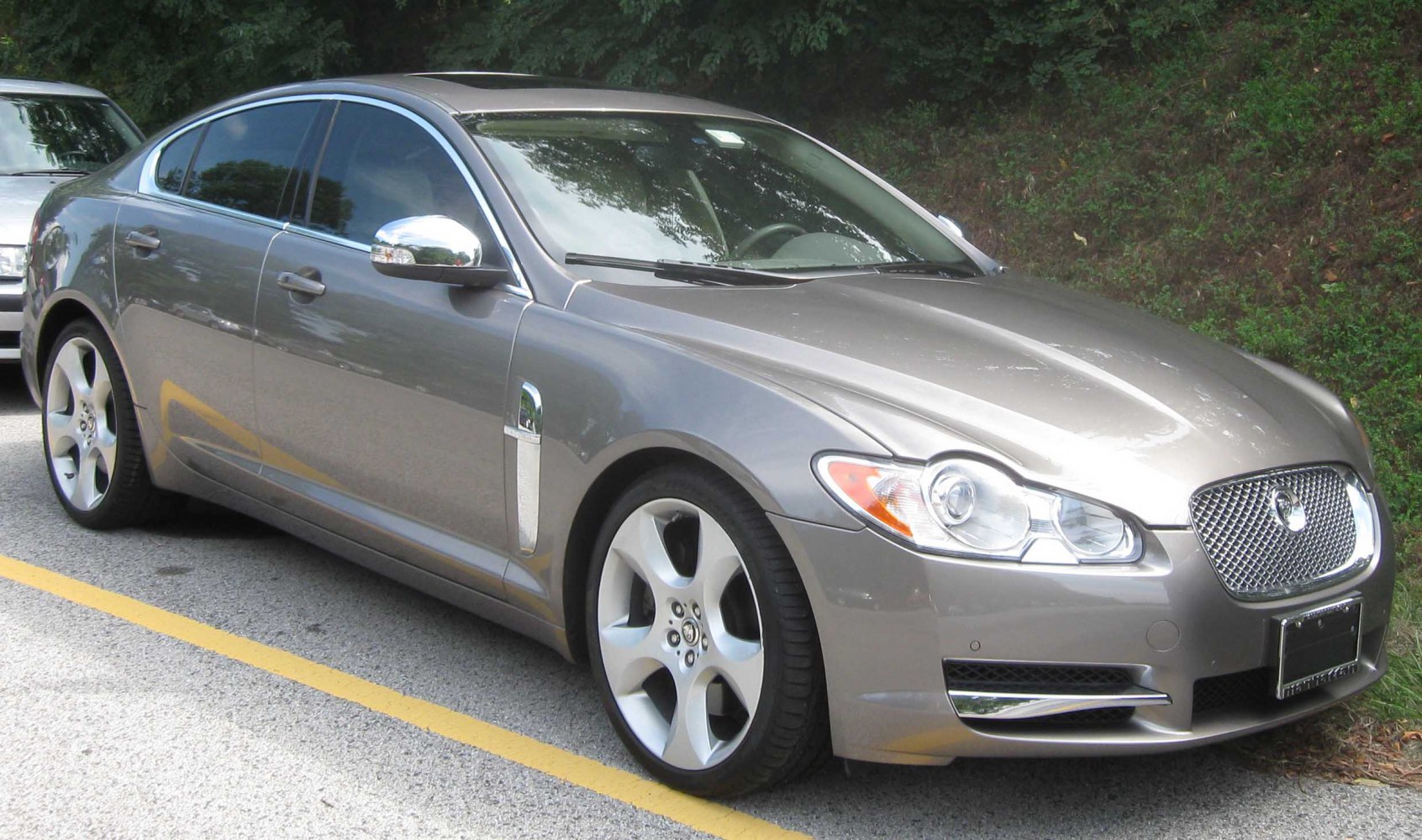 Luxury sedan with mesh front grille and five-spoke alloy wheels