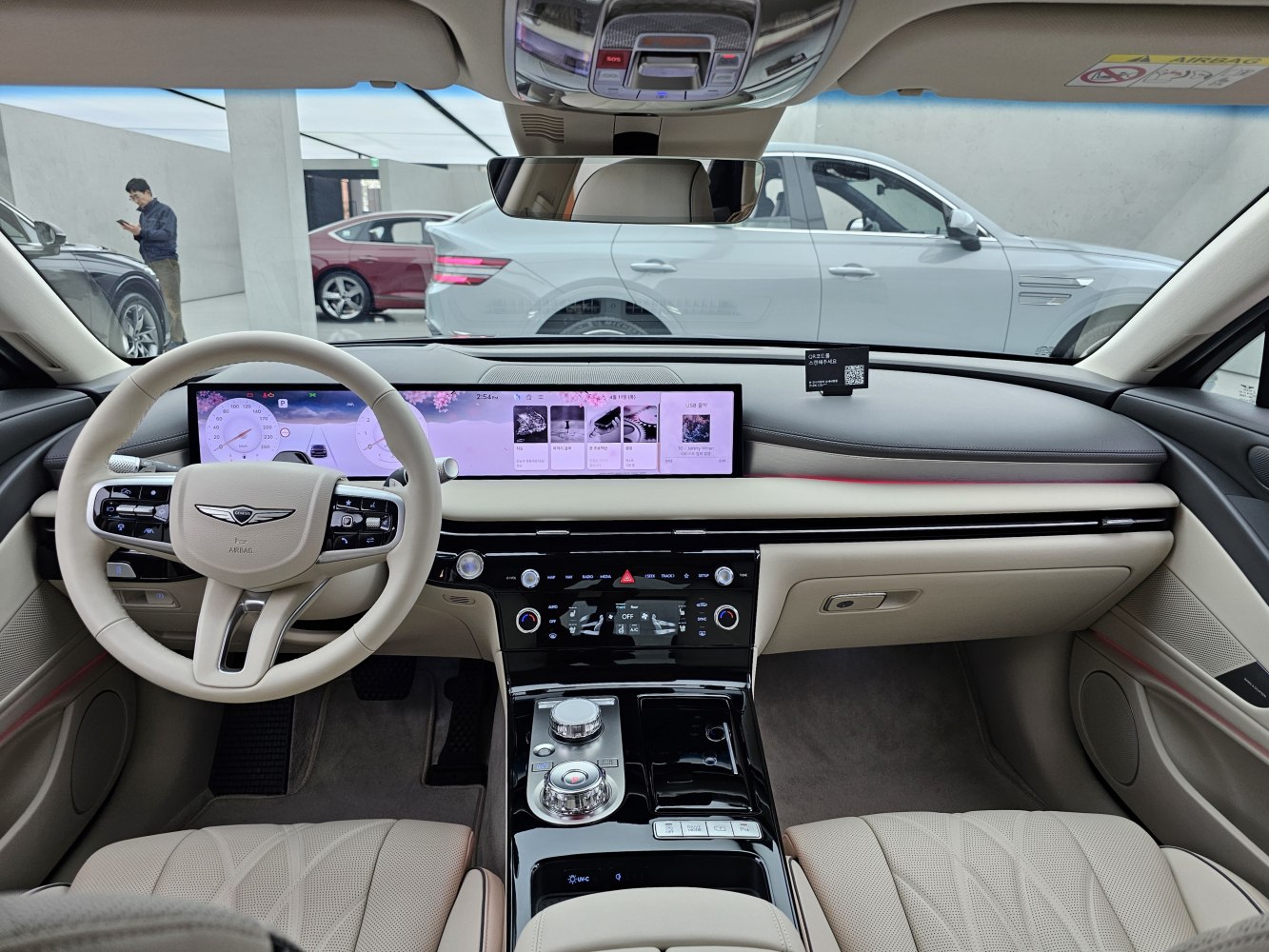 Dual digital dashboard with beige leather interior and advanced controls.