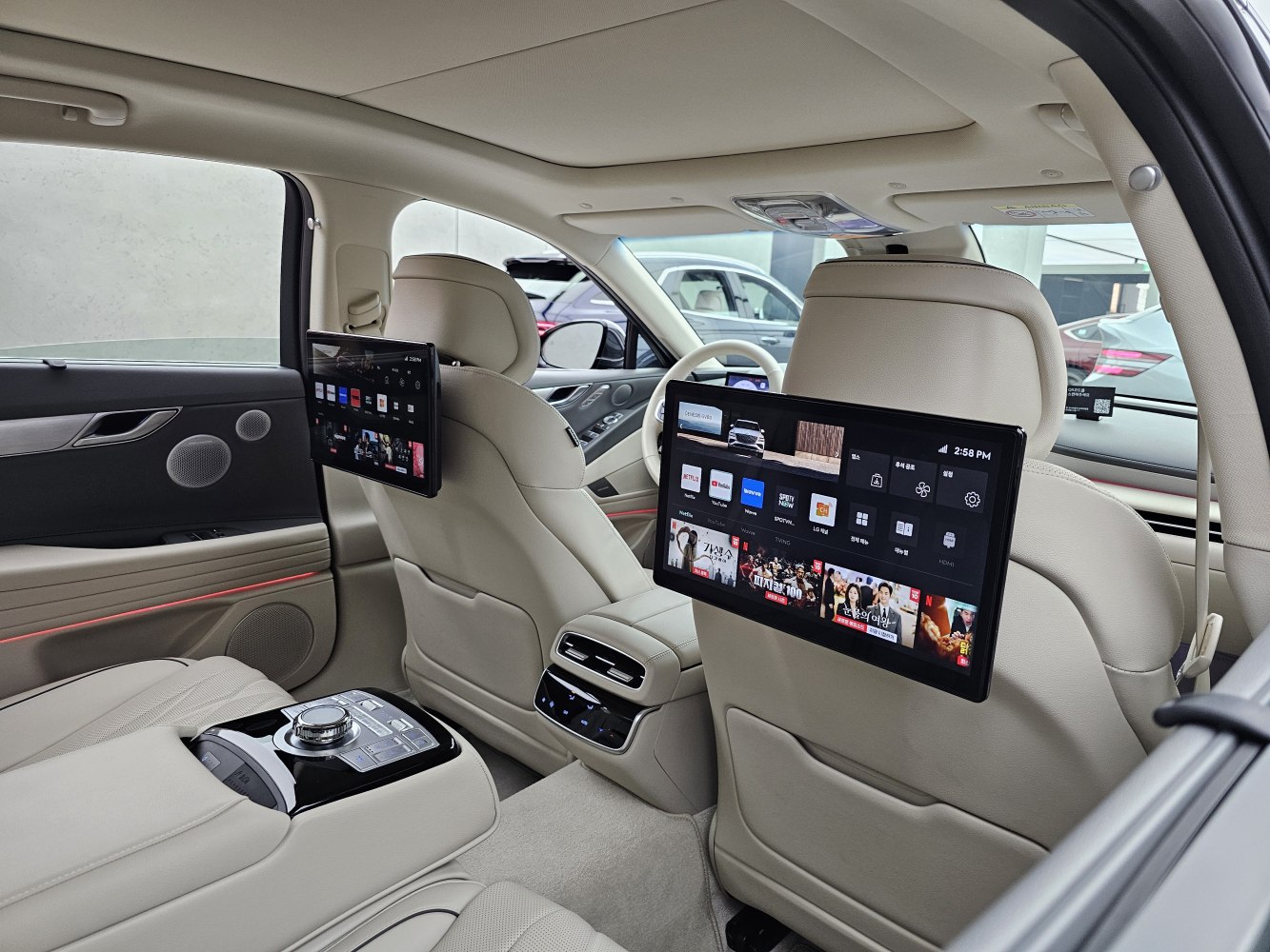 Rear seat entertainment screens with beige leather interior